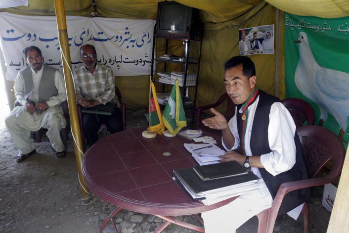 Ramazan Bashardost, a presidential candidate in the upcoming presidential election, talks with Afghans at his tent he named the Nation's Tent in Kabul, Afghanistan. Bashardost, a member of parliament and one of about 40 presidential candidates, spends much of his time working in the tent near the parliament building. 