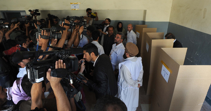 Abdullah casts his vote as a crush of media organizations attempt to document the moment. Abdullah gained momentum in the election largely through a series of increasingly spirited campaign appearances in which he called for political change.