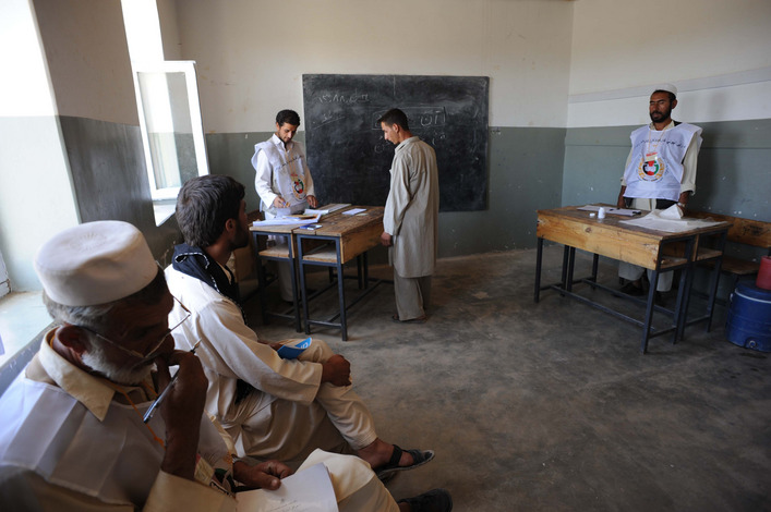 An  Afghan man prepares to cast his vote on election day in Istalif, an hour outside Kabul. Relatively low voter turnout in the Pashtun south, and stronger turnout in the north and west, were expected to hurt the reelection bid of favored President Hamid Karzai.