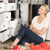 Photo of a woman in a cluttered closet.