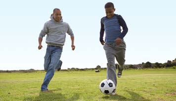 Photo of two kids playing soccer