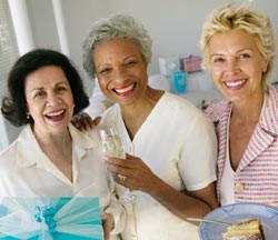 three women smiling at a birthday party