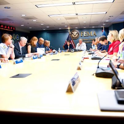 Photo: August 30 - DHS Secretary Janet Napolitano (head of the table) participates on the daily FEMA meeting regarding Hurricane Isaac response.  Seated around the table are numerous agencies and departments of the federal government, who are closely coordinating response and recovery efforts.