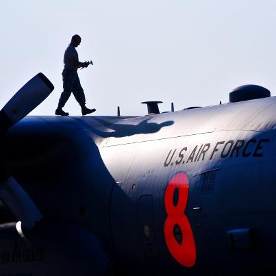Photo: Photo of the Day: U.S. Air Force Master Sgt. Rodney Hall walks the wing of a C-130 Hercules aircraft equipped with a firefighting system during a preflight inspection in Charlotte, N.C., Aug. 13, 2012. The 145th Airlift Wing, North Carolina Air National Guard, sent two C-130 Hercules cargo planes to California, where they fought fires at the direction of the U.S. Forest Service. U.S. Air Force photo by Tech. Sgt. Brian Christiansen