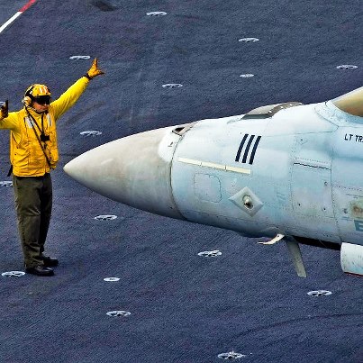 Photo: Photo of the Day: U.S. Navy Petty Officer 1st Class Forrest Findley directs an F/A-18F Super Hornet assigned to Strike Fighter Squadron 41 on the flight deck of the aircraft carrier USS John C. Stennis under way in the Pacific Ocean, Sept. 3, 2012. Findley is an aviation boatswain's mate. The John C. Stennis is returning to the areas of responsibility for the U.S. 7th and 5th fleets four months ahead of schedule to maintain combatant commander requirements in the region. U.S. Navy photo by Petty Officer 3rd Class Destiny Cheek