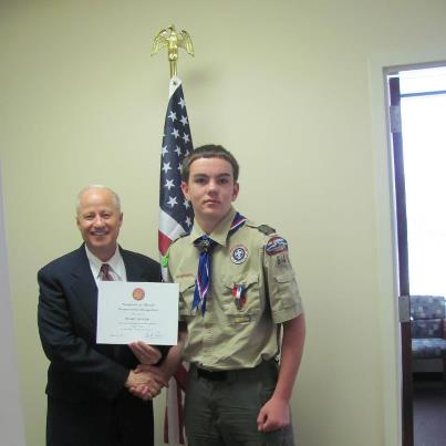 Photo: On August 14, I met with Blake Barger, son of Dr. Bret and Suzanne Barger,and presented him with a congressional certificate for receiving his Eagle Scout Award last Sunday. Blake is a member of Troop 640, sponsored by Genesis Presbyterian Church in Littleton, and completed all the requirements for his Eagle Award before his 14th birthday. For his Eagle project, Blake raised $6,000 and headed up 70 volunteers to plant 10,120 willow tree shoots, in one day, ten miles southwest of Deckers in the Hayman Fire burn area.