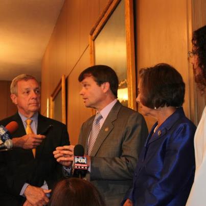 Photo: Mike speaks to reporters post forum along with Senator Dick Durbin, Representative Jan Schakowsky, and Attorney General Lisa Madigan.