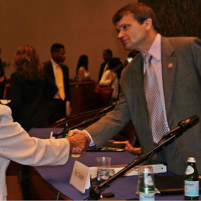 Photo: Mike greets Alderman Lona Lane after the student loan forum.