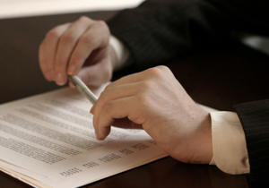 man in suit holding a pen