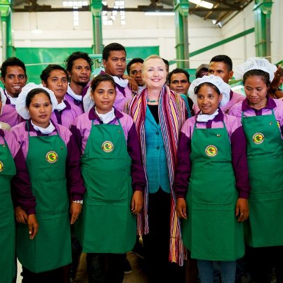 Photo: U.S. Secretary of State Hillary Clinton smiles with workers from the USAID founded Cooperativa Cafe Timor in Dili, Timor-Leste, September 6, 2012. The organic coffee cooperative brings income to over 21,000 Timorese families. [UNMIT photo by Bernardino Soares]