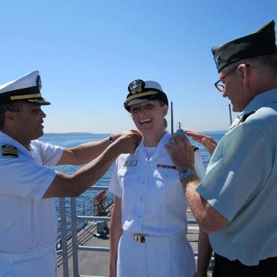 Photo: Capt. David Wilson, commanding officer, Naval Legal Service Office Northwest and Army Col. Bill Joy change out Lt. Eileen Joy's shoulder boards during a promotion ceremony on board USS Bunker Hill (CG 52). Joy was promoted to lieutenant by her father on board Bunker Hill during the 63rd annual Seattle Seafair Parade of Ships.