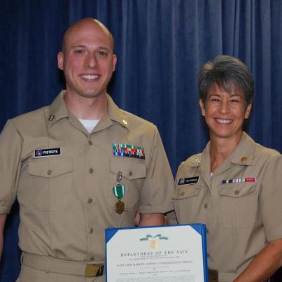 Photo: Vice Adm. Nanette DeRenzi presents Lt. Jeff Pietrzyk with the Navy and Marine Corps Commendation Medal at the Naval Justice School. The Commendation Medal is awarded to service members who distinguish themselves by heroism, outstanding achievement or meritorious service.