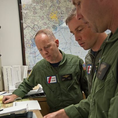 Photo: Lt. Audie Andry, Lt. Cmdr. Rob Donnell & Lt. Matthew Hunt, pilots from Aviation Training Center Mobile, look over charts before flying into hurricane affected areas. Coast Guard units all along the Gulf Coast pre-staged assets & personnel to better assist those in distress after Hurricane Isaac made landfall.