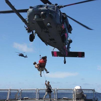 Photo: Teamwork in action: The Air National Guard worked with Coast Guard Cutter Morgenthau to rescue two fishermen 1,400 miles off the coast of Mexico. In this photo, an Air National Guard pararescue team with the 129th Rescue Wing is hoisted into an Air National Guard HH-60 helicopter from the deck of Morgenthau with one of the rescued fishermen.