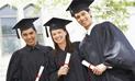 Three graduates in cap and gown