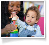 This is an image of a mother and her toddler playing with a toy