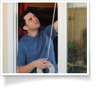 This is an image of a man weatherizing a house window