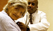 Doctor caring for an elderly patient image.