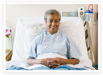 Smiling senior woman sitting up in a hospital bed
