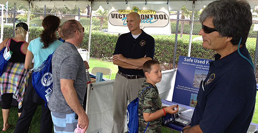 San Onofre Senior Resident Inspector Greg Warnick (left) and Resident Inspector John Reynoso talk to members of the public about the NRC at the Dana Point Safety Expo. 
