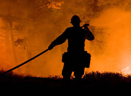 Photo of firefighter extinguishing blaze