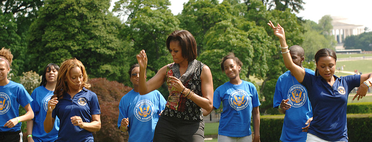 Michelle Obama, Dominique Dawes and others exercising on the White House lawn.