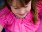 Photo of a young girl using a ruler on a piece of paper.