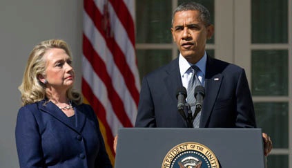 Flanked by Secretary Clinton, President Obama addresses a Rose Garden press conference / AP Image