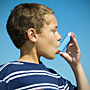 A boy uses an inhaler