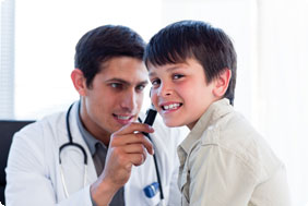 Doctor Examining Ear of Little Boy