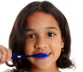 Young girl with brown hair brushing teeth
