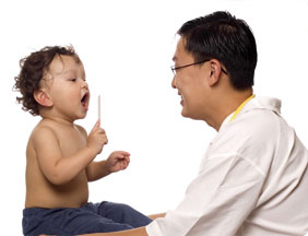 Child at doctor, playing with medical equipment