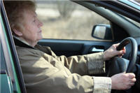 An older woman driving. 