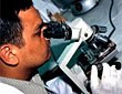 A technician using a microscope