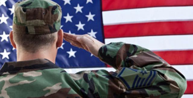 Veteran saluting U.S. flag