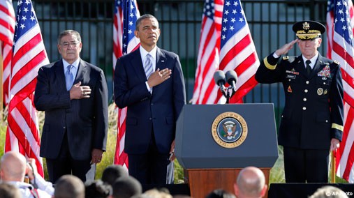 President Barack Obama, flanked by Defense Secretary Leon Panetta, left, and Joint Chiefs Chairman Gen. Martin Dempsey, marks the eleventh anniversary of the terrorist attacks at the Pentagon, on September 11, 2012. [AP Photo]
