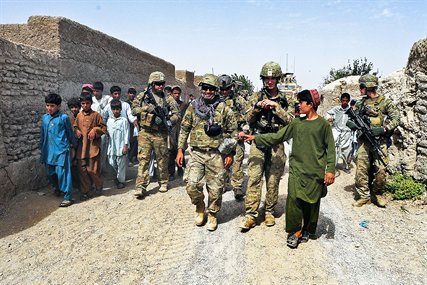 U.S. service members assigned to Provincial Reconstruction Team Farah enjoy a laugh with Afghan children during a patrol in Dizak village in Afghanistan's Farah province, Sept. 12, 2012.