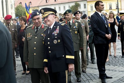 U.S. Army Gen. Martin E. Dempsey, chairman of the Joint Chiefs of Staff, talks with a NATO chairman of defense in Sibiu, Romania, Sept. 14, 2012.