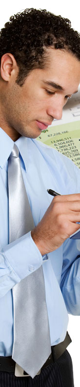 Image of a man with a pen and an accounting spreadsheet