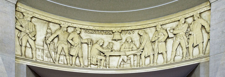 Photograph of relief artwork in the Department of Justice depicting the signing of the Constitution.