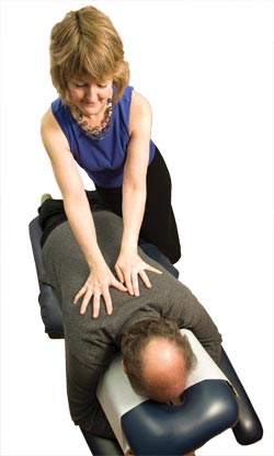 A chiropractor practices spinal manipulation on a patient.