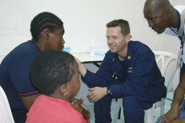 LCDR Joseph Simon speaks to patients in Colombia.