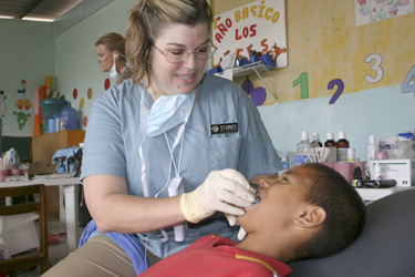 LCDR Lisa Starnes treats a patient in Manta, Ecuador.