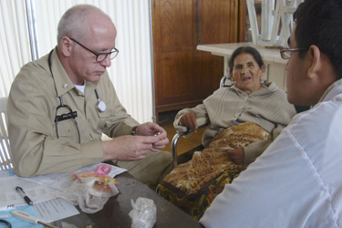 CDR Kevin Prohaska treats a patient in Peru.