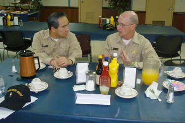 Acting Surgeon General RADM Kenneth P. Moritsugu and CAPT Bruce Boynton, Commanding Officer?USNS Comfort, have a post-breakfast discussion.