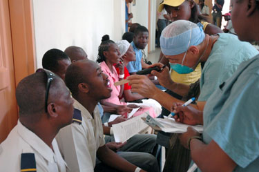 Dentist CAPT Angel Rodriguez-Espada examines teeth in Port-au-Prince, Haiti.