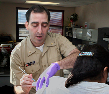 United States Public Health Service nurse treating a patient at an IHS facility