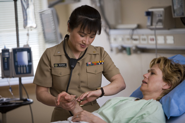 United States Public Health Service Commissioned Corps nurse examining a patient