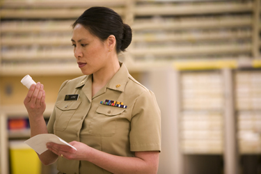 United States Public Health Service Commissioned Corps pharmacists reviews a prescription
