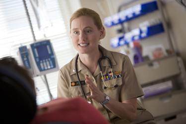 CAPT Sarah Linde-Feucht, a United States Public Health Service Commissioned Corps physician, speaking with a patient